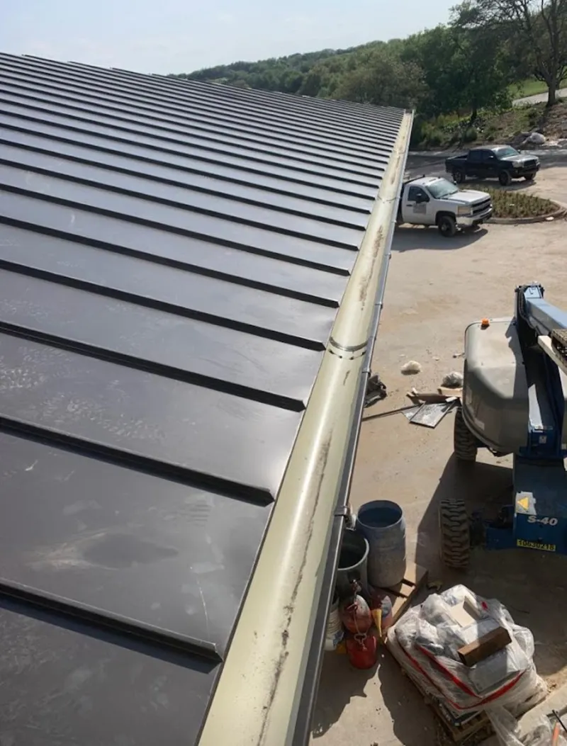 Standing seam panel and gutter detail on a metal roofing jobsite in Bellevue